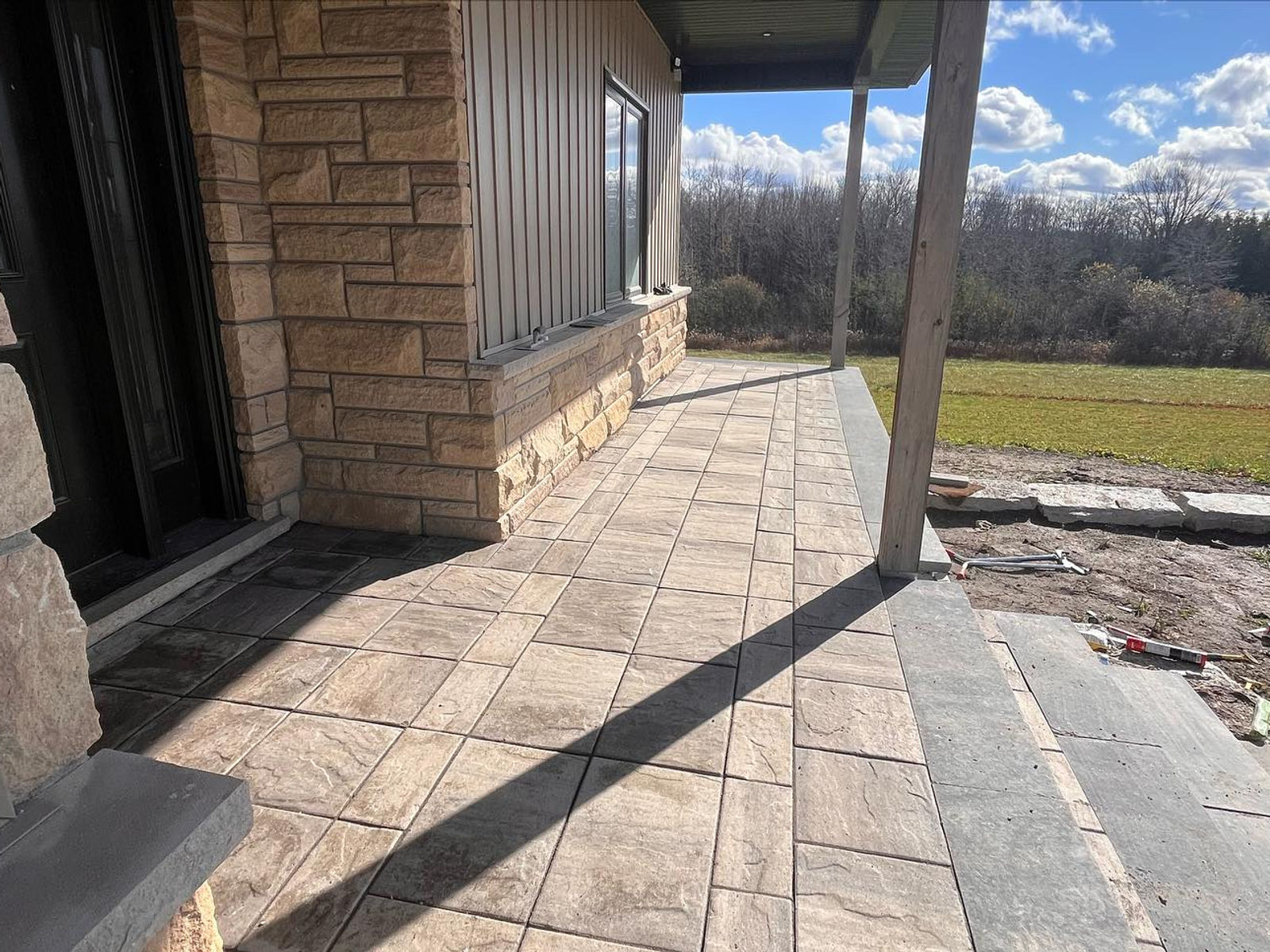 Stone and interlock entrance with mature plantings